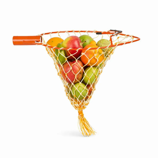 Fruit net bag filled with apples and oranges on a white background