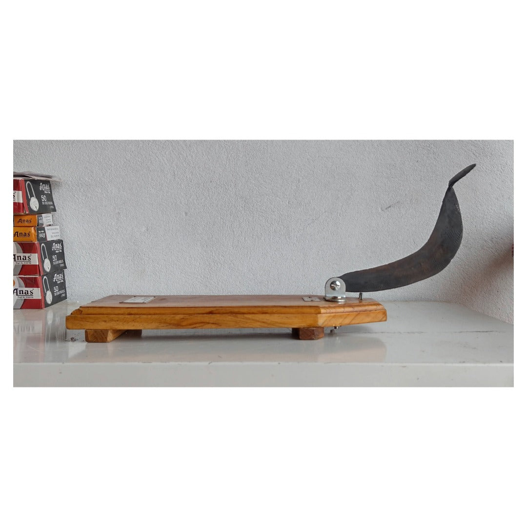 Wooden vili with a curved blade on a white surface