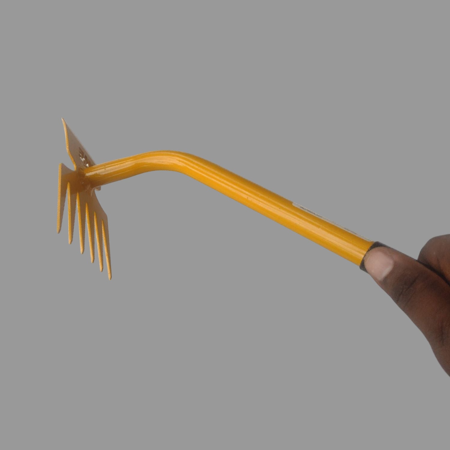 Garden weeder tool with a yellow handle on a white background