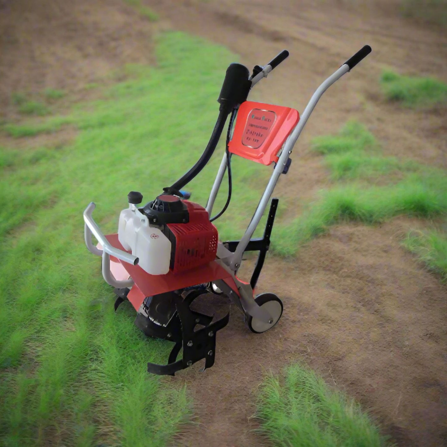 Small red and white mini power tiller machine on a grassy field