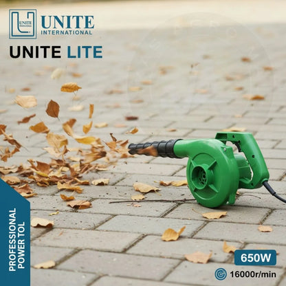 Green leaf blower being used to clear leaves on a paved surface, with 'UNITE' branding visible.