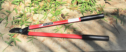 Sunya Pruning Lopper with red and black handles on a grassy background