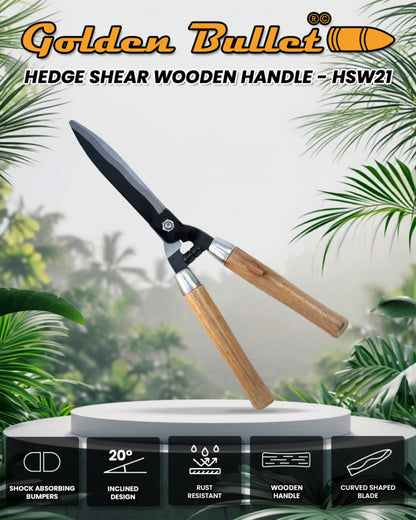 Hedge shear with wooden handle on a white pedestal against a green leafy background, branded 'Golden Bullet'.