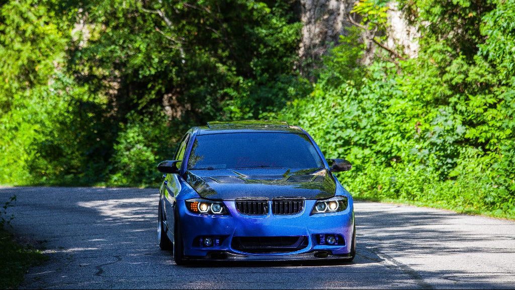 Blue sports car driving in a jungle - Vikas Agro Mall